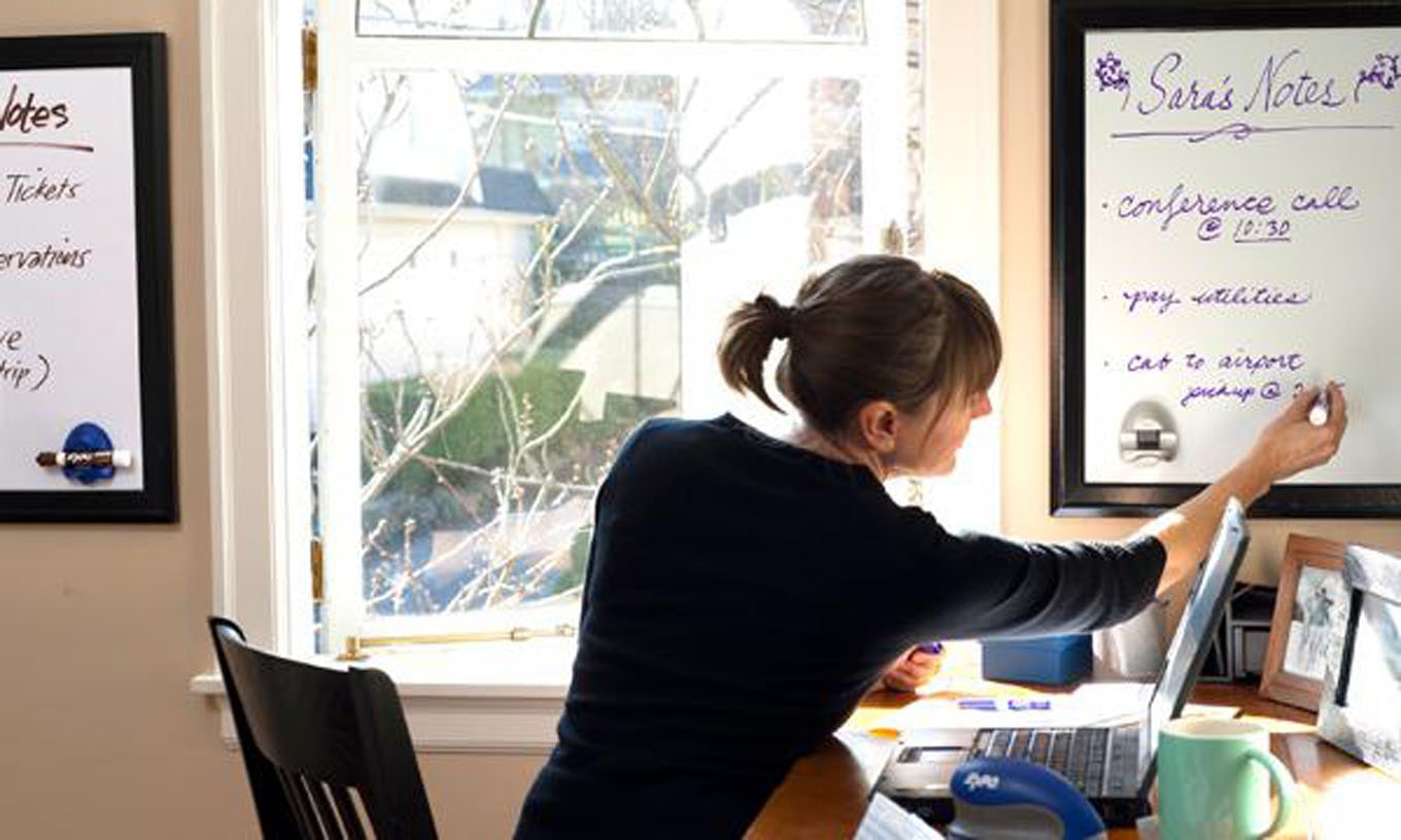woman-writing-on-whiteboard-at-desk.jpg