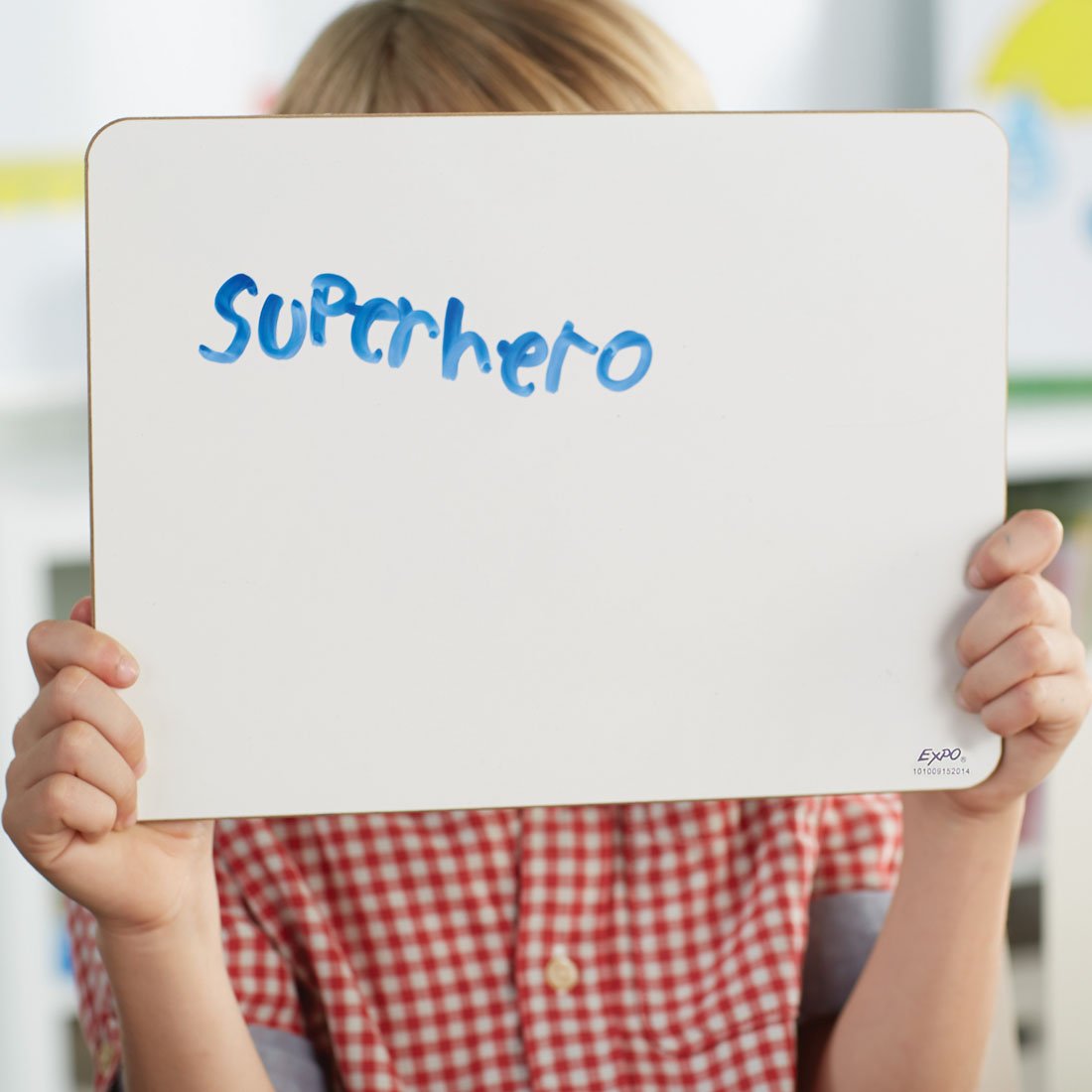 student-holding-up-individual-whiteboard-with-superhero-written-on-it.jpg