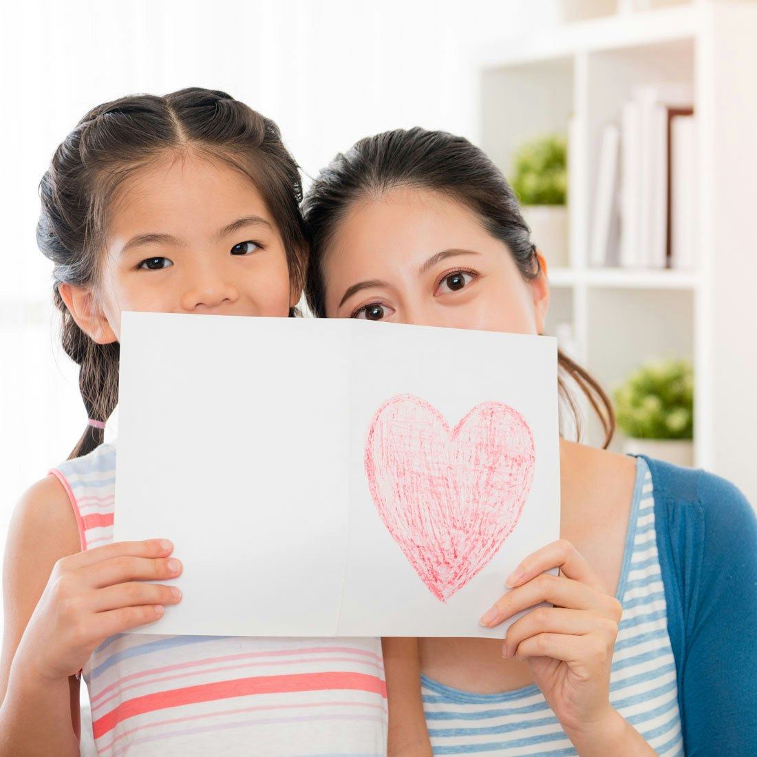 mom-and-daughter-holding-drawing-of-heart.jpg