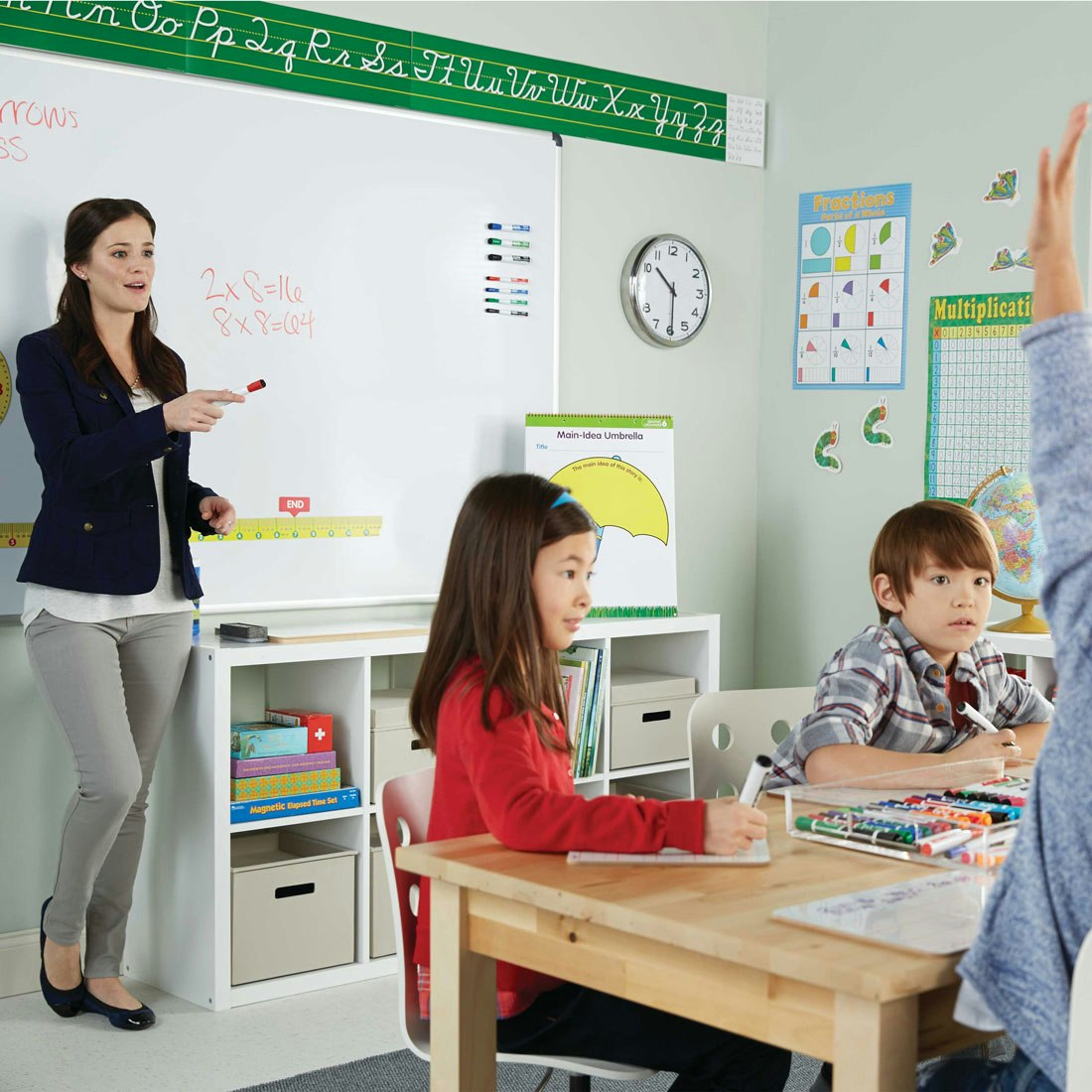 teacher-leading-classroom-standing-at-whiteboard.jpg