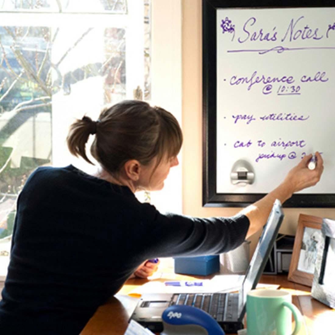 woman-writing-on-whitebaord-with-purple-expo-marker.jpg