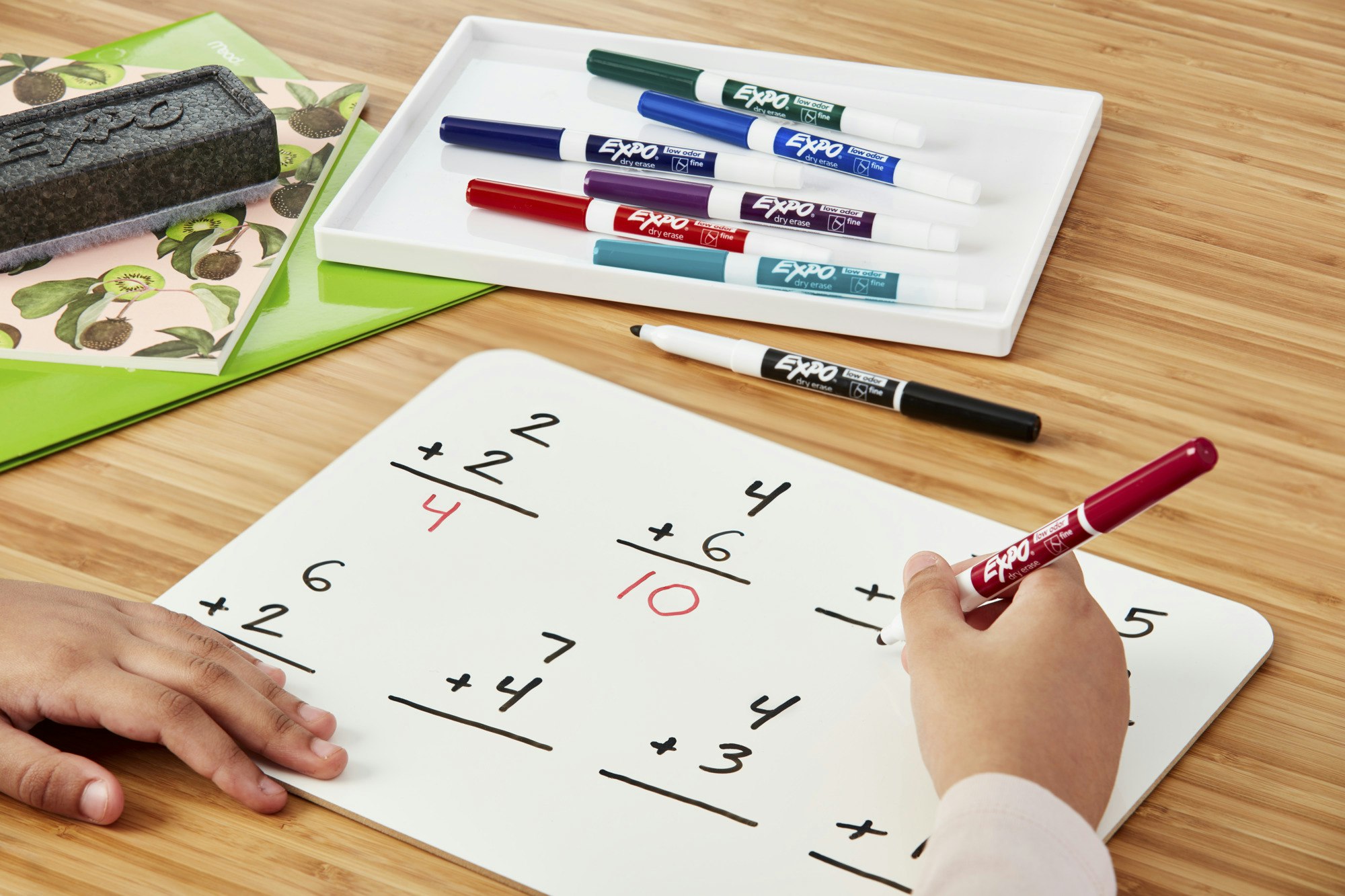 student-holding-an-individual-whiteboard-with-a-math-problem-on-it.jpg